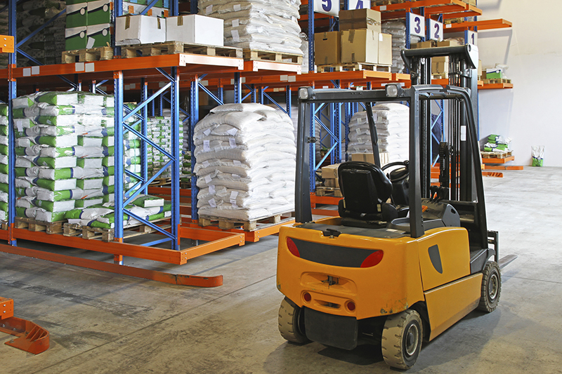 Forklift truck in distribution warehouse